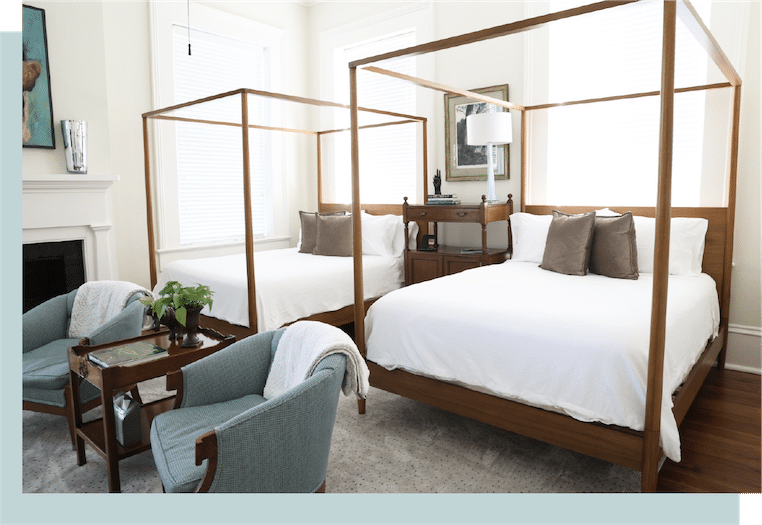 Room with 2 beds and 2 chairs